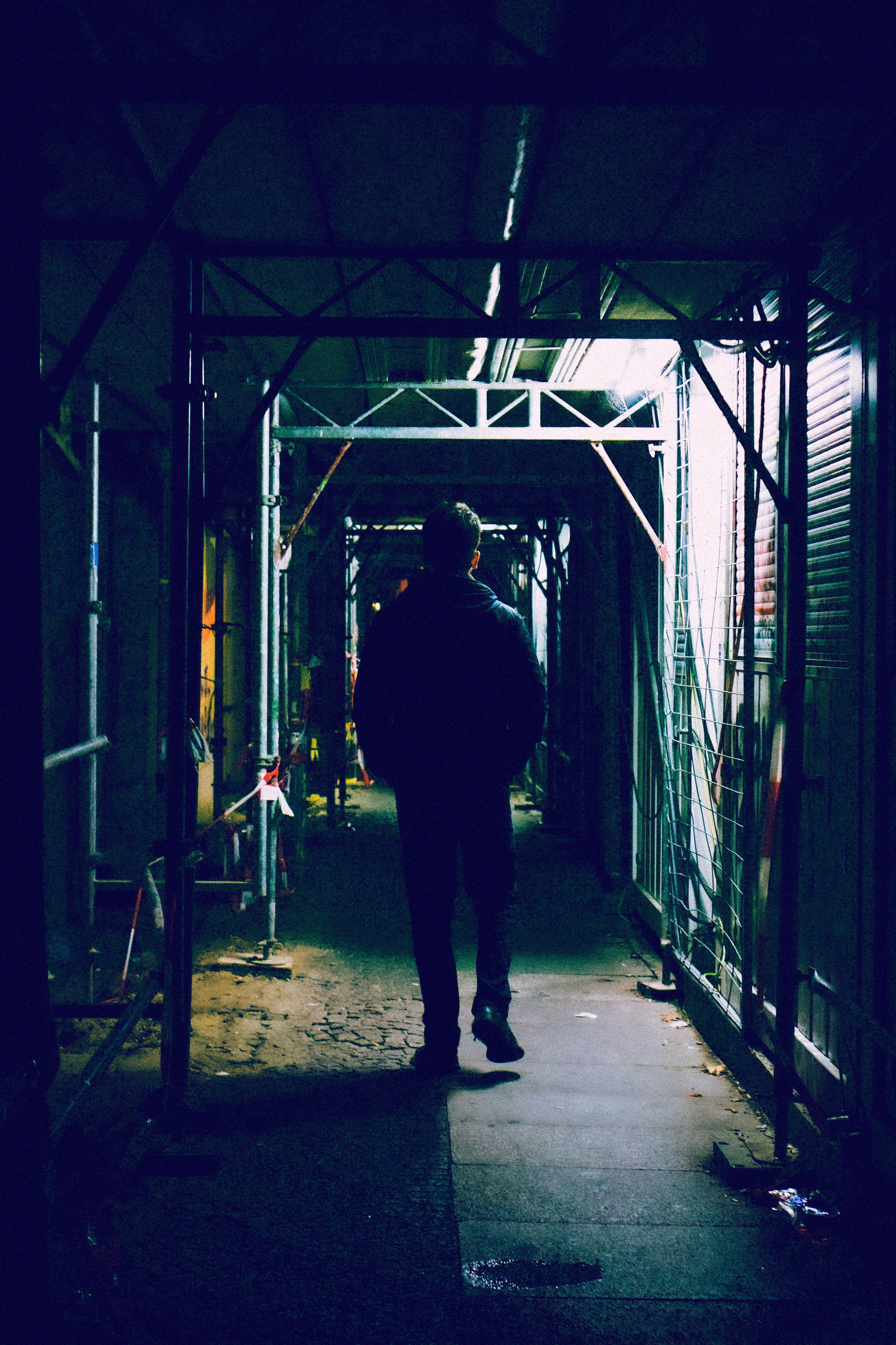 person standing under grey building